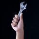 Photo of a hand holding a wrench